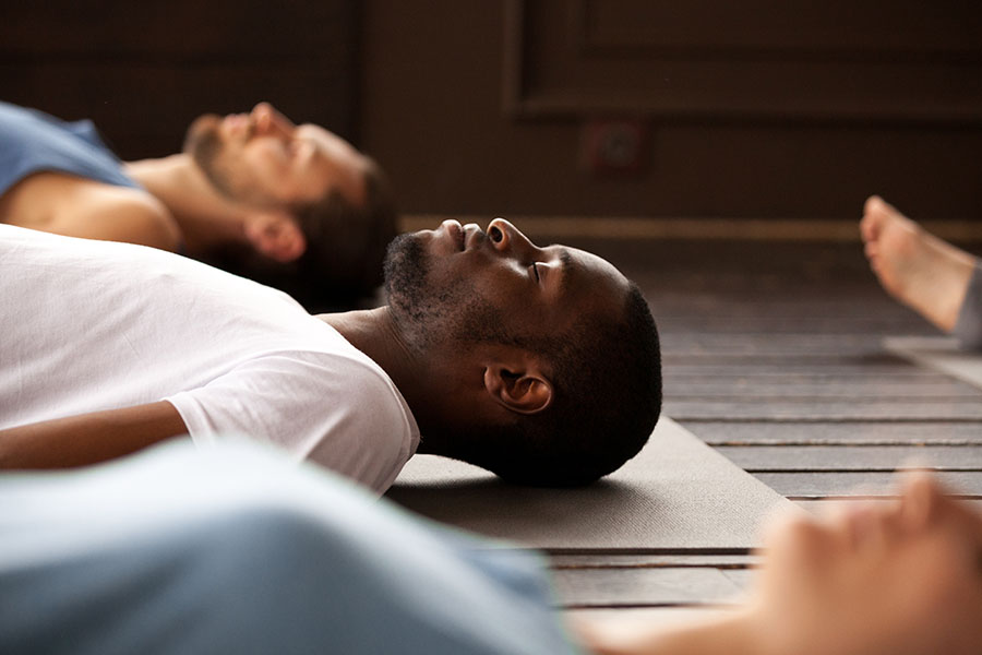 People laying on yoga mats