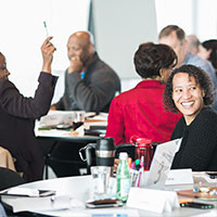 Workshop attendees seated at tables