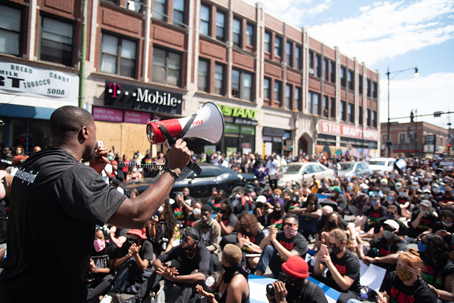 Person with megaphone at large protest march