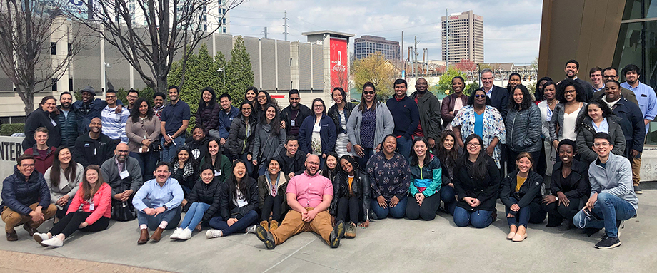 A large group of Bridgespan team members posing outdoors