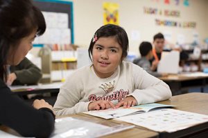 Teacher helps a student with reading