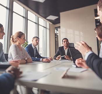 Team members seated at a meeting table