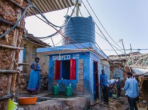 People gathered near a clean water wash station