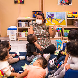 early childhood educator reading to toddlers