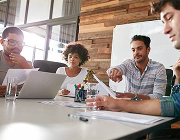 A team collaborating around a work table