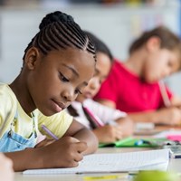 Girl writing at desk