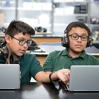 Two students working on laptops