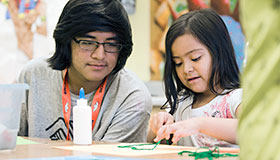 Two children working on a project at a table