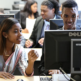 Woman and Man at a computer screen - Year Up