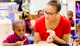 Woman helping young child - Educare, New Orleans